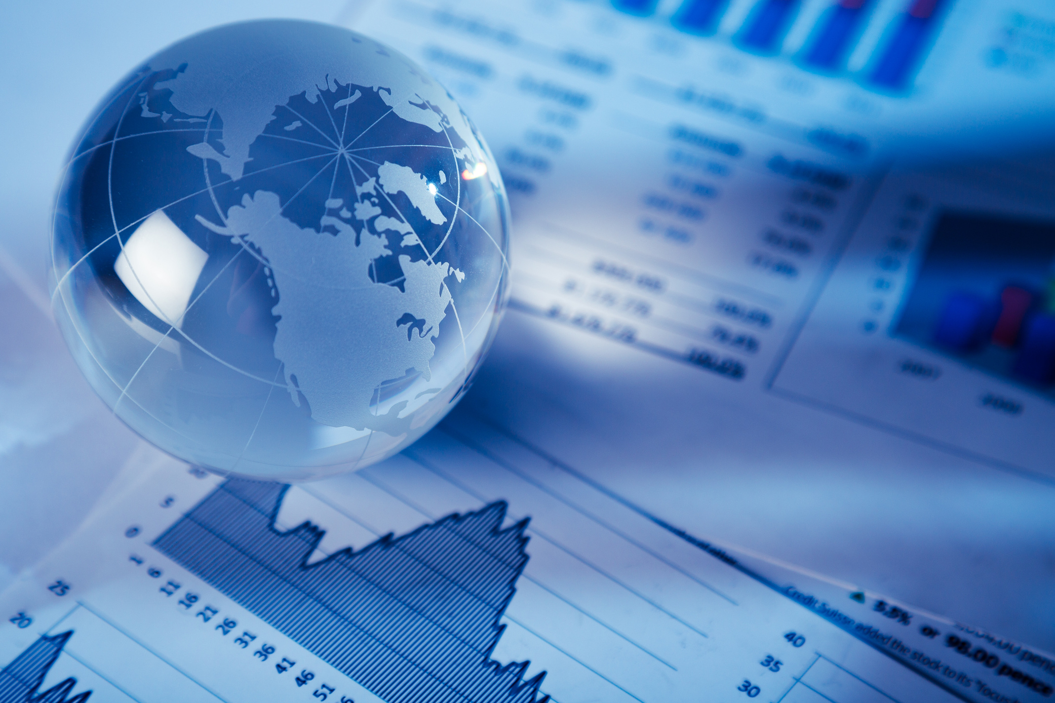 Glass Globe On Financial Reports Close-up